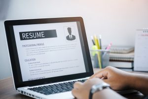 A man is updating his resume as it's currently out of the hiring season.